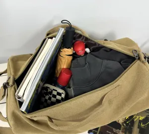 Detailed interior view of a large capacity canvas duffel bag with travel essentials