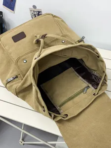 Durable khaki canvas drawstring backpack with interior zip pocket for travel and school.