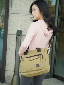 Stylish khaki canvas messenger bag for women with multi-compartment design for commuting.