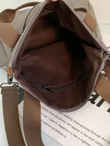 Detailed internal view of vintage canvas tote bag with multi-compartment lining and zipper