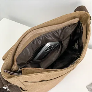 High-capacity khaki canvas messenger bag interior view with multiple compartments