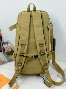 Back view of a large capacity khaki canvas travel backpack with multi-functional straps