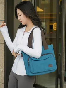 Fashionable large capacity blue canvas tote bag for women with multi-compartments.