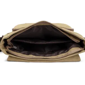 Internal compartment detail of a khaki men's canvas messenger bag with zipper pocket.