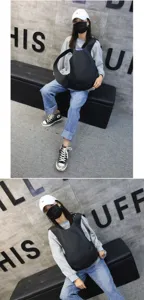 Black minimalist backpack shown in a casual urban streetwear style outfit