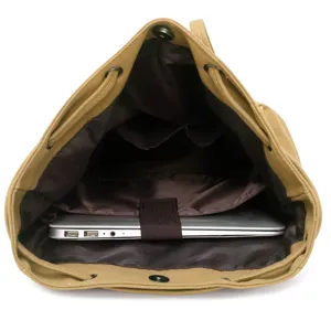 Vintage khaki canvas backpack showing spacious interior with laptop compartment.