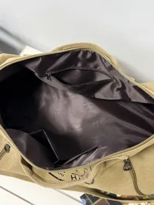 Large khaki canvas travel duffel bag showing spacious interior and lining detail