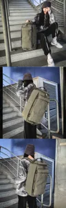 Large-capacity olive green outdoor travel canvas cylindrical backpack shown with model