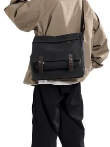Large black canvas messenger bag for men featuring stylish double buckle straps