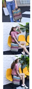 Detail view of a multi-color striped canvas bag on model sitting on yellow chair