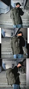 Outdoor lifestyle view of the large green canvas travel backpack on a model