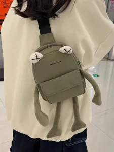Adorable green frog-shaped crossbody chest bag featuring plush limbs and iconic X-eye design
