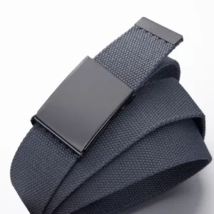 Detailed close-up of dark grey canvas belt with black metal automatic buckle, casual style.