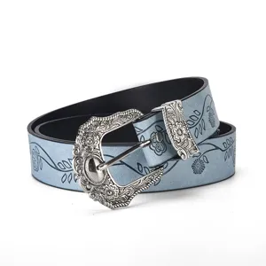Detailed view of light blue vintage leaf print leather belt with ornate silver buckle