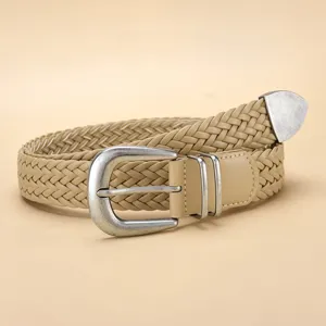 Detailed macro view of beige PU woven belt featuring a vintage silver metal pin buckle