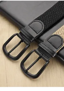Close-up detail of woven elastic braided belts with metal pin buckle, casual fashion design.