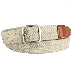 Detailed close-up of a beige woven elastic belt featuring a silver pin buckle and brown leather end.
