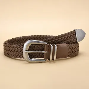 Close-up detail of a vintage brown PU braided belt with a distressed metal pin buckle.