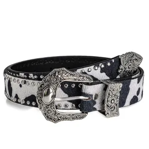 Retro cow print studded leather belt detail with intricate carved silver metal buckle and rivets.
