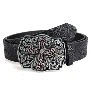 Close-up of vintage embossed belt with ornate silver and red cross buckle detail.