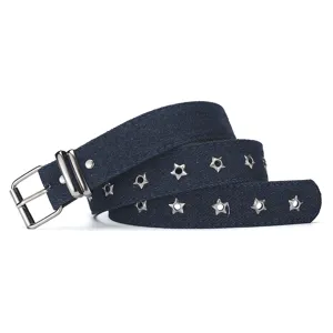 Close up view of the dark blue denim belt featuring metallic star shaped eyelets and buckle.