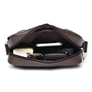 Interior view of brown men's messenger bag showing space for phone and essentials