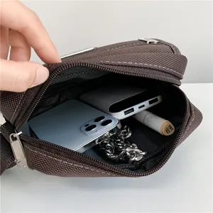 Modern mens fashion Oxford cloth messenger bag showing large internal capacity for phone
