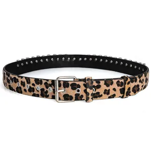 Detailed view of leopard print studded belt with punk rock grommet metal hardware