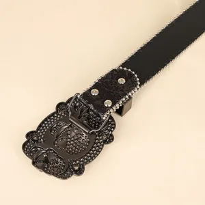 Close-up of hip-hop style black belt with ornate buckle and silver beaded edges