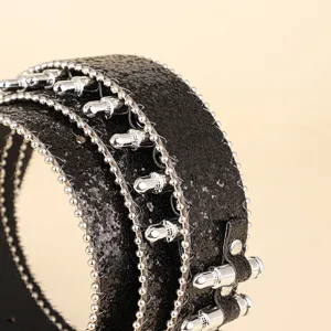 Macro detail of heavy hip-hop black sequin belt with silver bullet studs and bead-chain trim