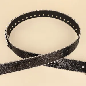 Macro view of black glitter belt with silver stud edges and metallic eyelets