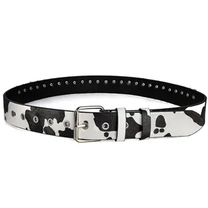 Detailed close-up of cow print punk belt with metal rivets and sturdy silver buckle
