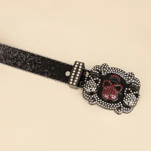 Close-up of black sequined belt with rhinestone skull buckle detail