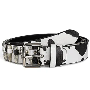 Detailed view of cow print leather belt with bullet-shaped metal studs