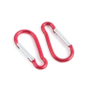 Close up detail shot of red aluminum alloy spring carabiner clips for outdoor backpacks.