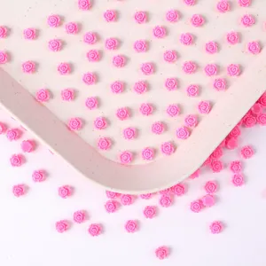 Detail view of 6mm pink resin miniature flower cabochons for nail art, phone case and DIY craft.