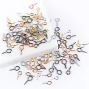 Detailed close-up of mini metal screw eyes, eye pins, and pendant bails in assorted colors.