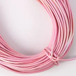 Detailed macro view of 5mm pearlescent pink PU leather cord with fine edge stitching