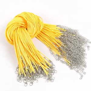 Detailed view of yellow waxed necklace cords with lobster clasps and extension chains