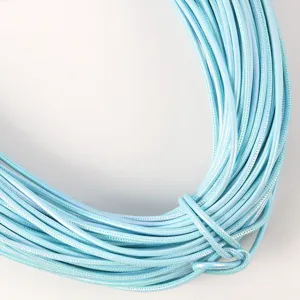Macro view of 5mm pearlescent light blue PU leather cord with stitched detail