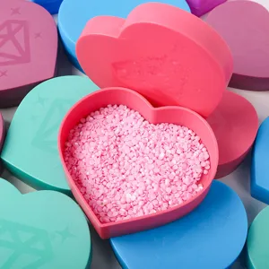 Detailed view of an open heart-shaped diamond painting tray with pink resin diamonds