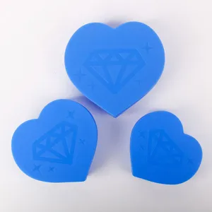Close-up of three blue heart-shaped diamond painting sorting trays with diamond pattern