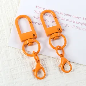 Orange lobster clasp swivel U-shaped metal ring keychain DIY craft accessory detail shot.
