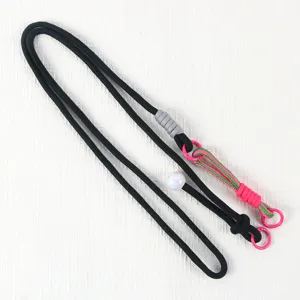 Close-up detail of the black crossbody phone lanyard featuring a vibrant pink green braided segment.