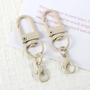 Detail shot of light khaki swivel lobster clasp keychains, DIY hardware accessories.