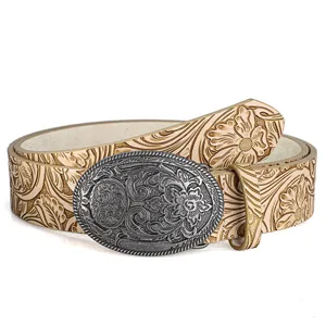 Detail view of Western cowboy leather belt with floral embossing and carved buckle.