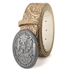 Detailed view of retro western cowboy belt with embossed floral leather and carved buckle