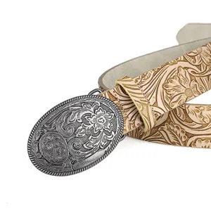 Macro view of embossed peony floral patterns and silver-tone engraved oval belt buckle