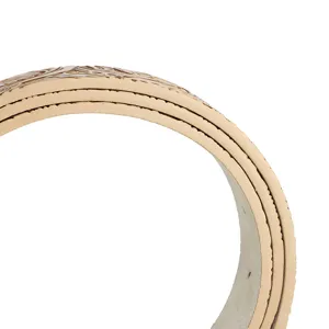 Detailed close-up showing the layered edge and embossed peony pattern on a tan leather belt