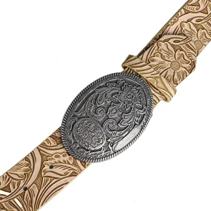 Close-up of vintage Western cowboy belt with ornate floral carved silver buckle